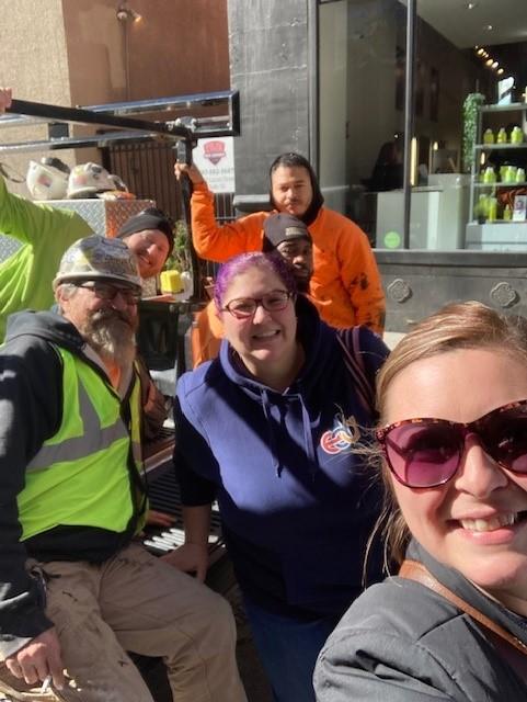 Selfie of four EDA employees sitting on back of truck