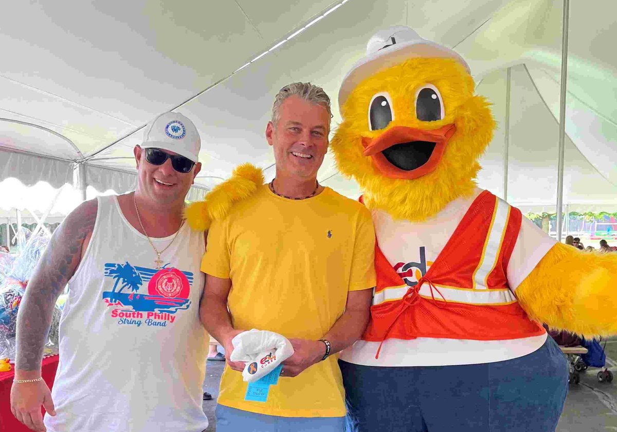 Two men with duck mascot
