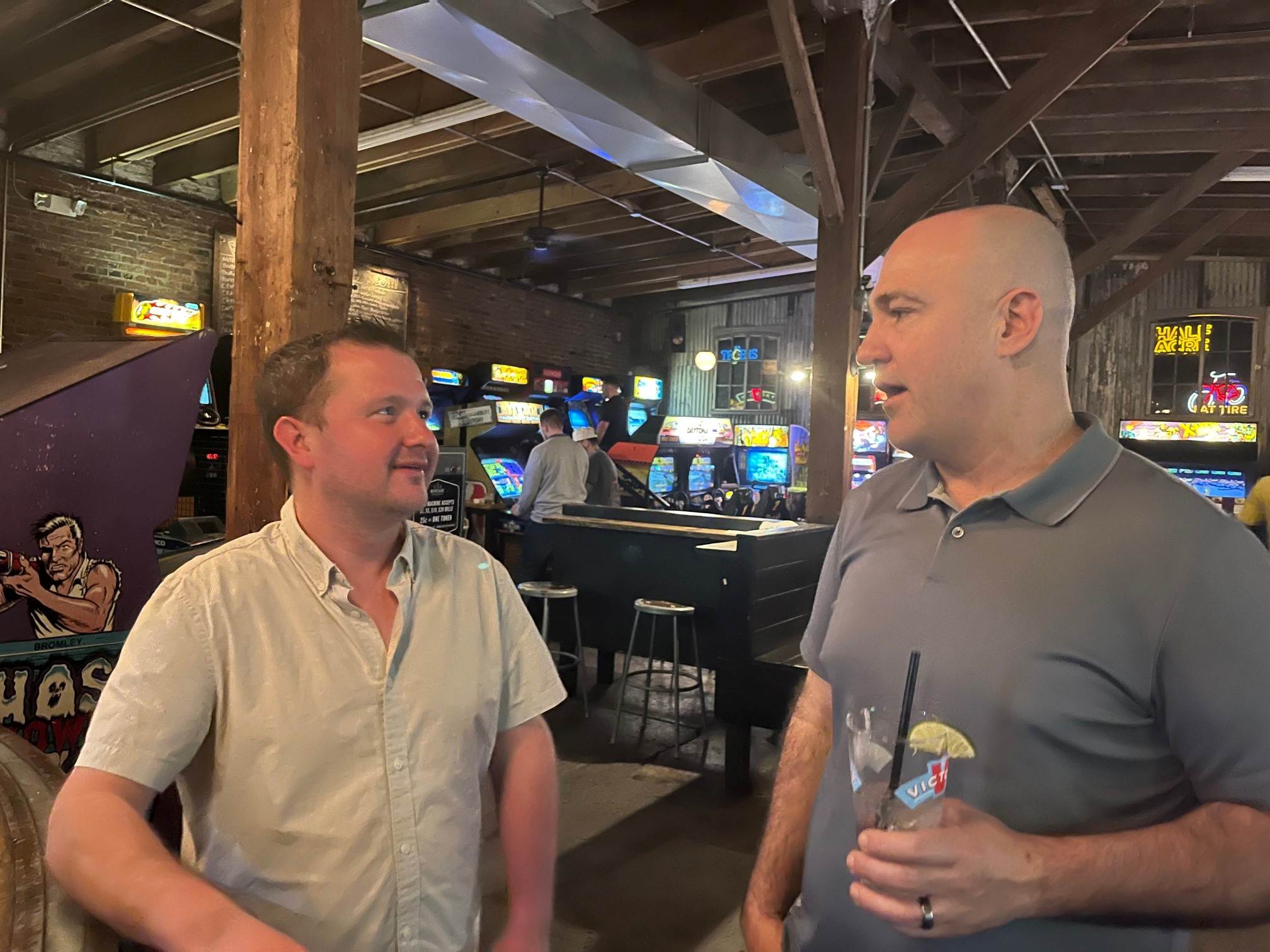 Two individuals speaking at restaurant
