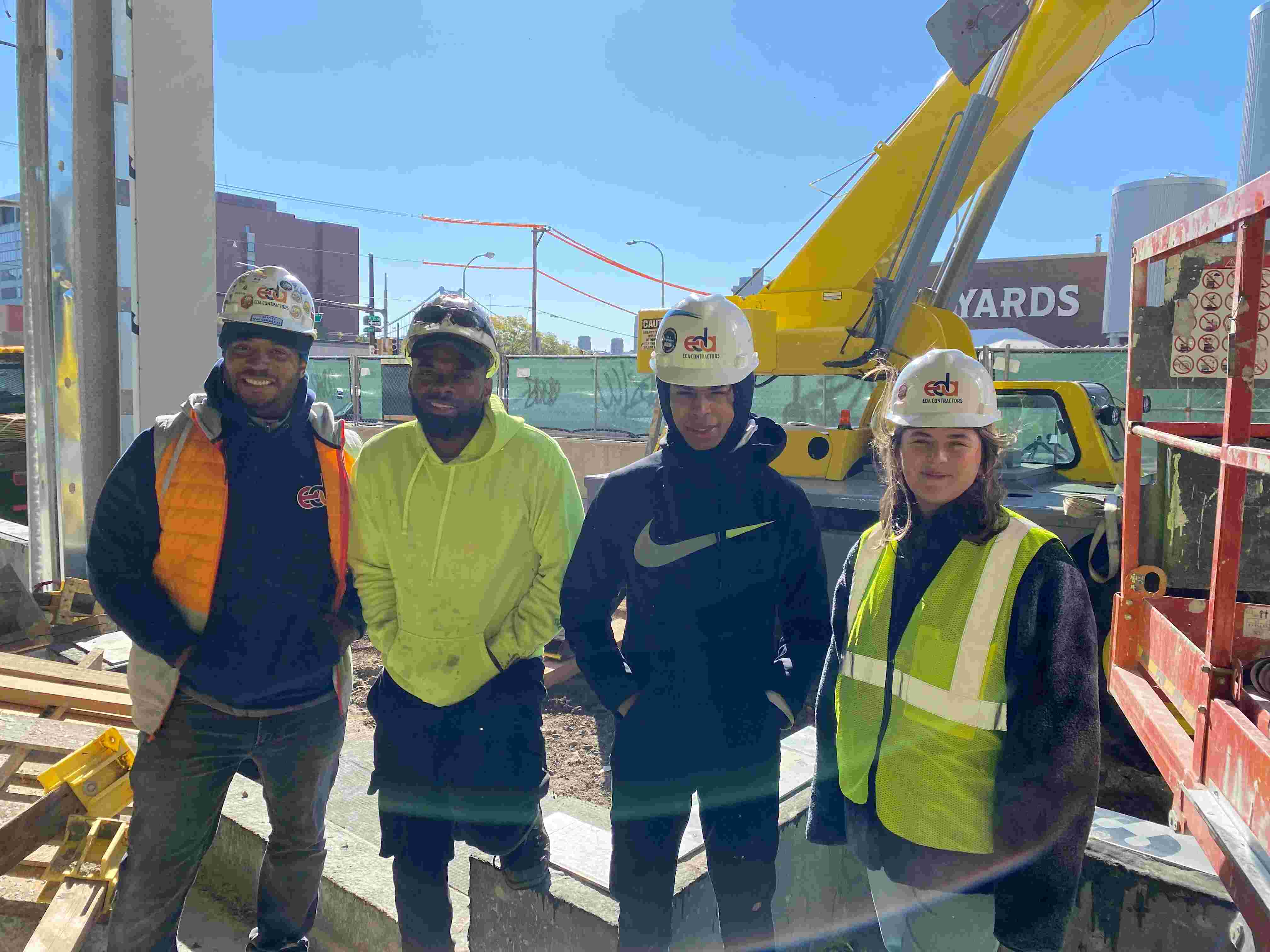 Group of construction workers in front of lift